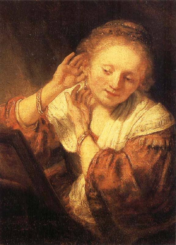 REMBRANDT Harmenszoon van Rijn Young Woman Trying on Earrings Sweden oil painting art